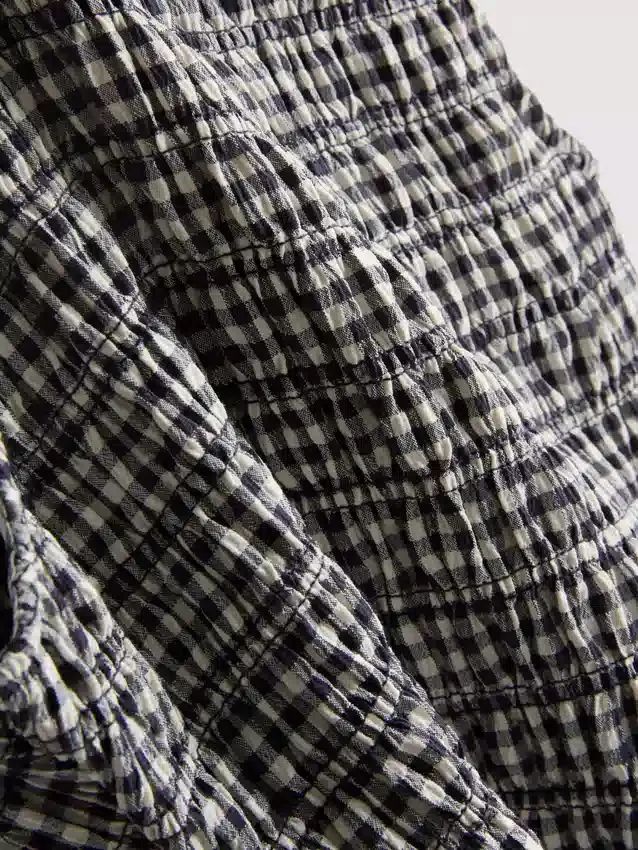7–15 Jahre | gerafftes, ärmelloses Kleid mit Gingham-Muster 7–15 Jahre | gerafftes, ärmelloses Kleid mit Gingham-Muster