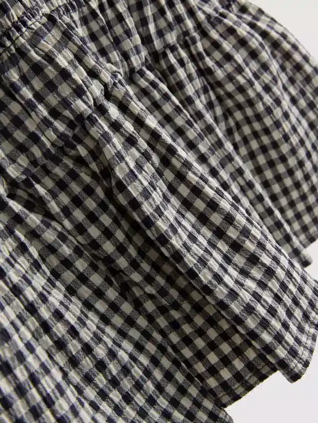 7–15 Jahre | gerafftes, ärmelloses Kleid mit Gingham-Muster 7–15 Jahre | gerafftes, ärmelloses Kleid mit Gingham-Muster