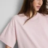 Bauchiges Baumwoll-T-Shirt mit Rundhalsausschnitt Bauchiges Baumwoll-T-Shirt mit Rundhalsausschnitt
