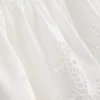 Cami-Top aus Baumwolle mit besticktem Peplum-Saum